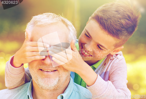 Image of grandfather and grandson playing at summer park