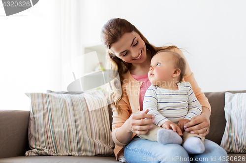 Image of happy young mother with little baby at home