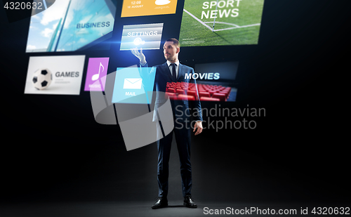 Image of businessman with applications on virtual screen