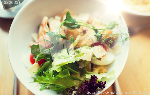 Image of close up of caesar salad on plate at restaurant