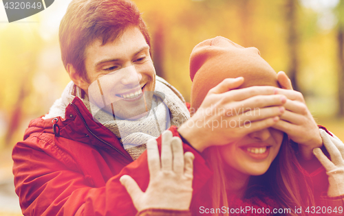 Image of happy young couple having fun in autumn park