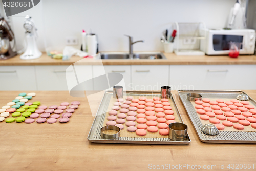 Image of macarons on oven trays at confectionery