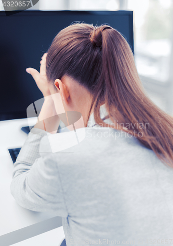 Image of stressed woman with computer