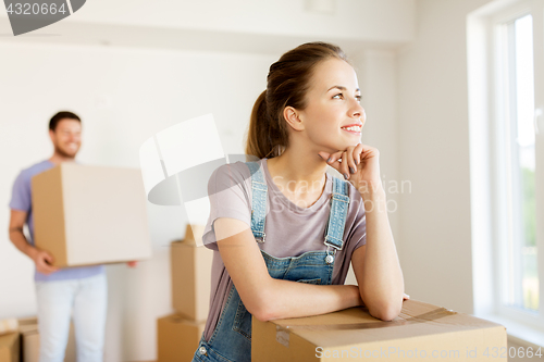 Image of happy couple with boxes moving to new home