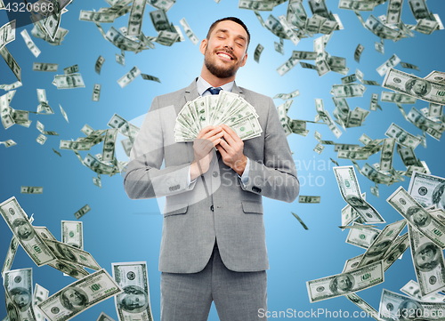 Image of smiling businessman with american dollar money