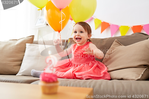 Image of happy baby girl on birthday party at home