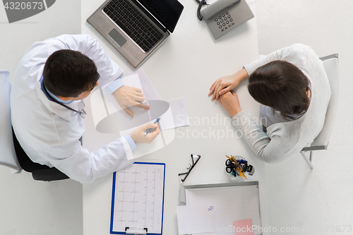 Image of doctor with prescription and patient at hospital