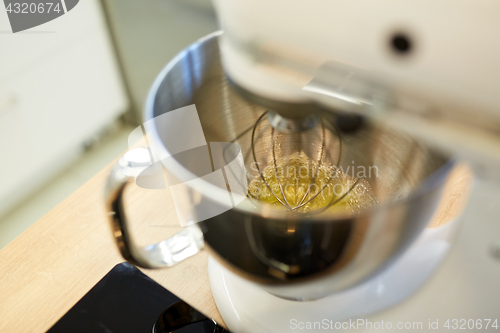 Image of electric mixer whipping egg whites at kitchen