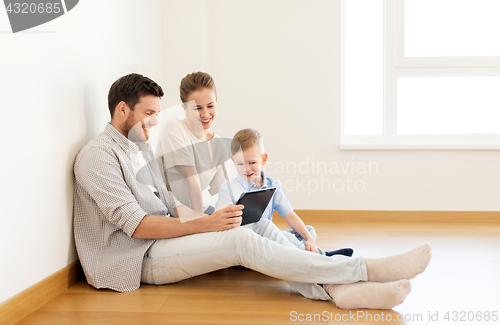 Image of happy family with tablet pc moving to new home