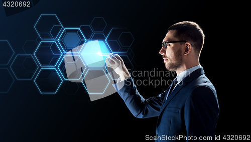 Image of businessman working with virtual network hologram