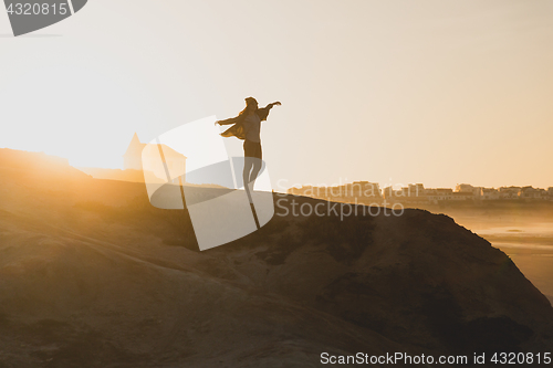 Image of Woman over the cliff