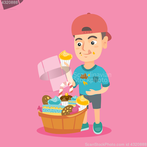 Image of Boy holding a cupcake and stroking his belly.