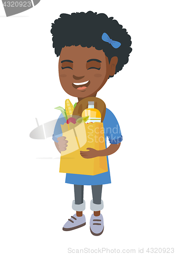 Image of Girl holding paper shopping bag full of groceries.