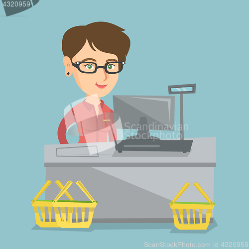 Image of Cashier standing at the checkout in a supermarket.