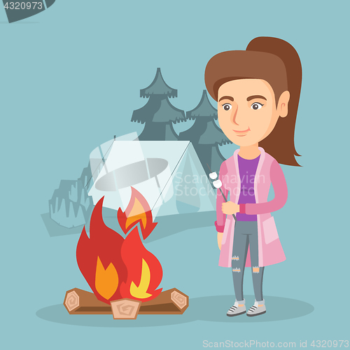 Image of Caucasian woman roasting marshmallow over campfire