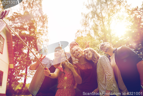 Image of friends taking selfie at party in summer garden