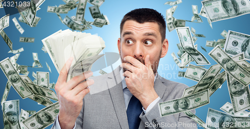 Image of smiling businessman with american dollar money