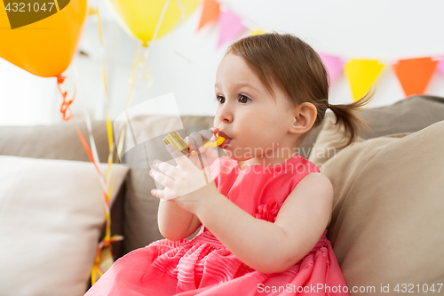 Image of happy baby girl on birthday party at home