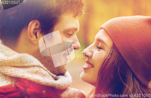 Image of close up of happy young couple kissing outdoors