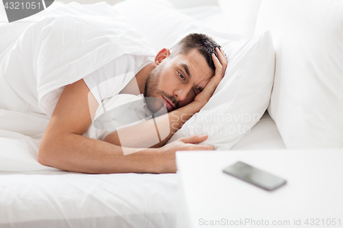 Image of young man looking at smartphone