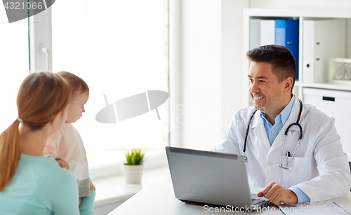 Image of woman with baby and doctor with laptop at clinic