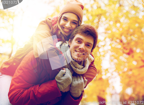 Image of happy young couple having fun in autumn park