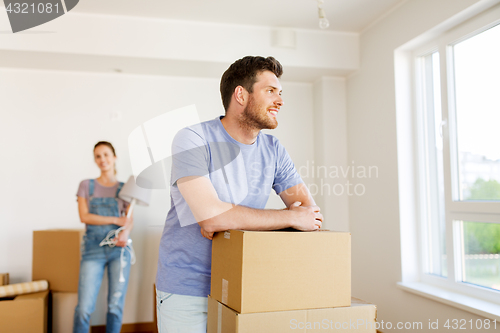 Image of happy couple with boxes moving to new home