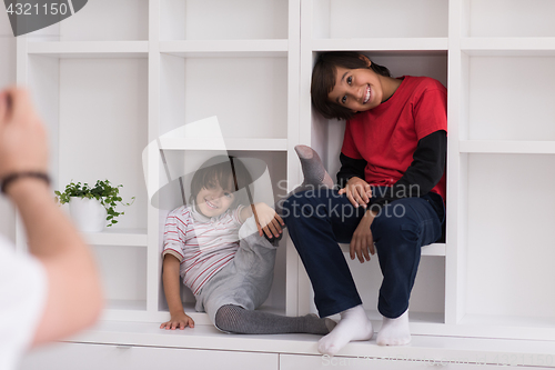 Image of young boys posing on a shelf