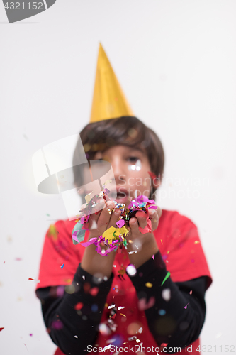 Image of kid blowing confetti