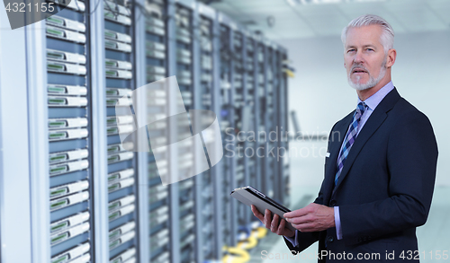 Image of Senior businessman in server room