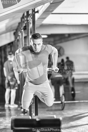 Image of man doing exercises parallel bars