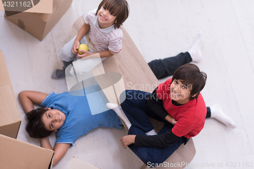 Image of boys with cardboard boxes around them top view