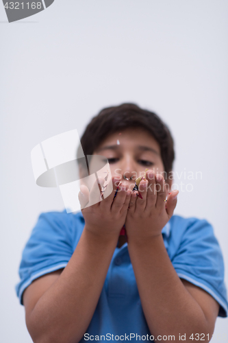 Image of kid blowing confetti