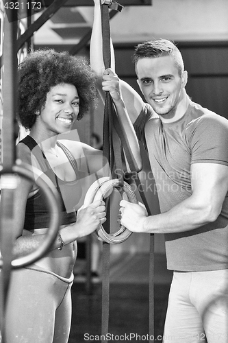 Image of Portrait of multiethnic couple  after workout at gym