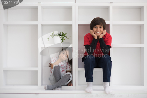 Image of young boys posing on a shelf