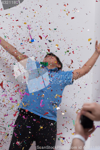 Image of kid blowing confetti