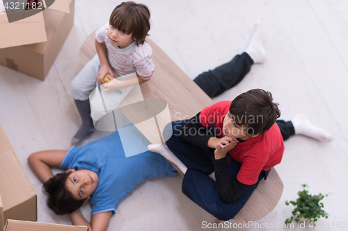 Image of boys with cardboard boxes around them top view