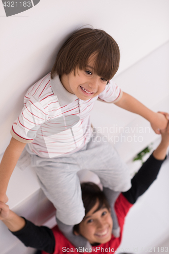 Image of young boys posing line up piggyback top view