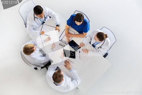 Image of doctors with cardiograms and tablet pc at hospital