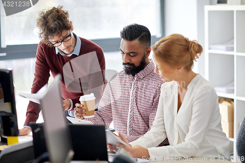 Image of business team with tablet pc in office