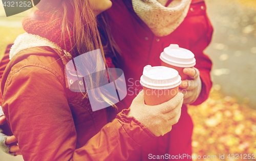 Image of close up of happy couple with coffee in autumn