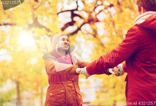 Image of happy young couple having fun in autumn park