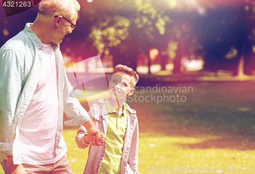 Image of grandfather and grandson walking at summer park