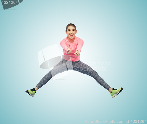 Image of happy smiling sporty young woman jumping in air