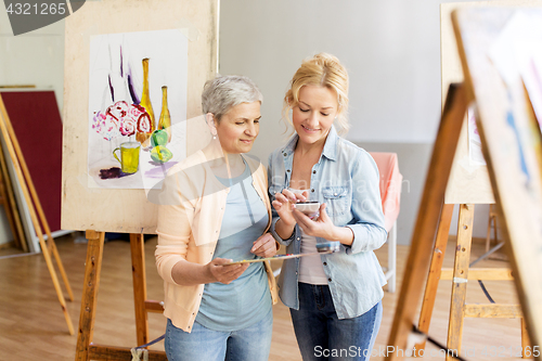 Image of artists with smartphone painting at art school