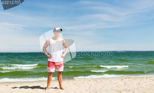 Image of smiling young man on summer beach