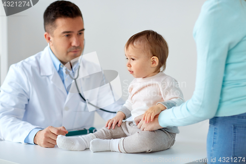 Image of happy woman with baby and doctor at clinic