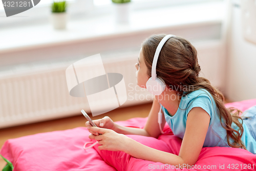 Image of girl in headphones listening to music at home