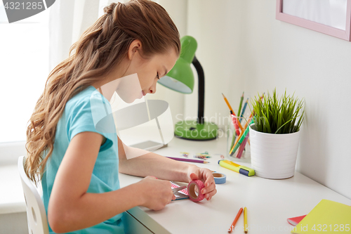 Image of happy girl making something at home