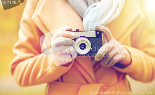 Image of close up of woman with camera in autumn park